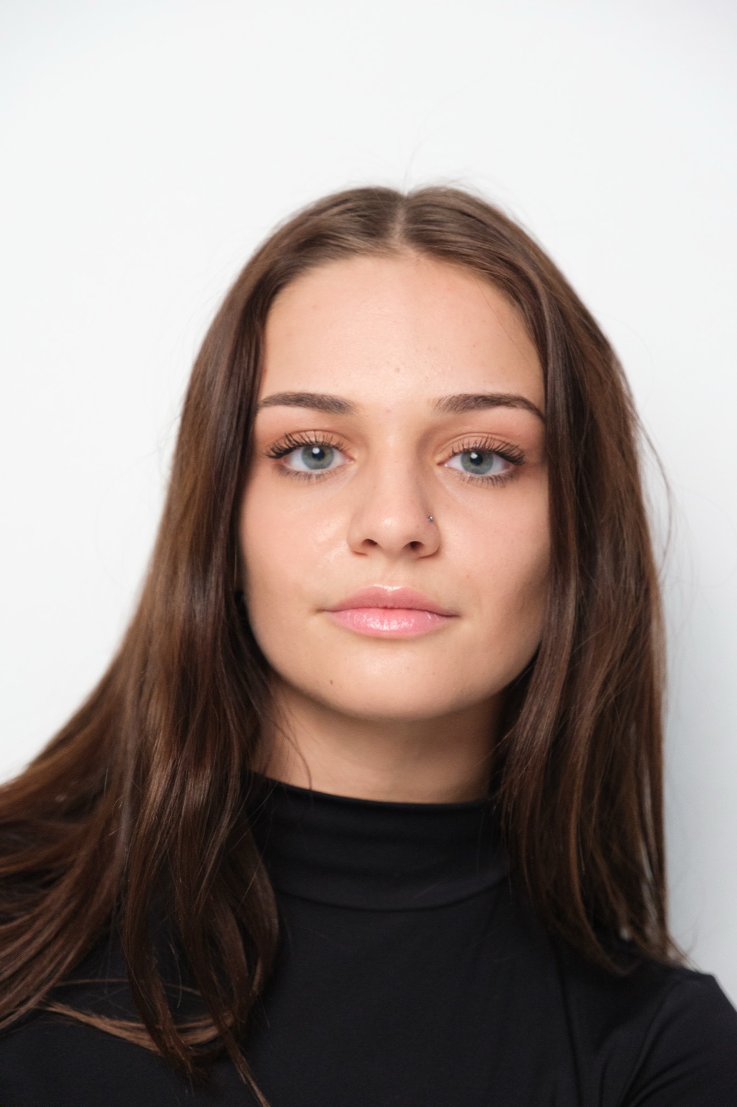 Studio headshot, woman in headscarf