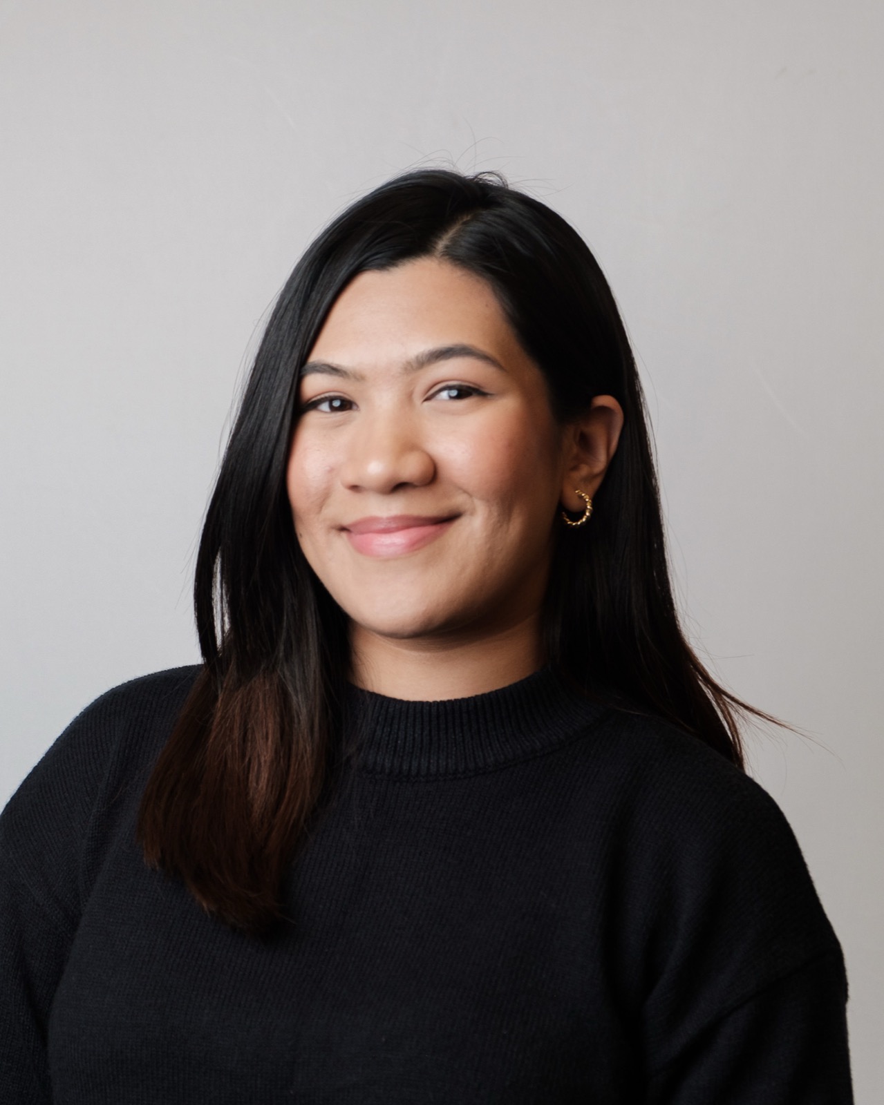 Professional studio headshot, woman in glasses and blazer