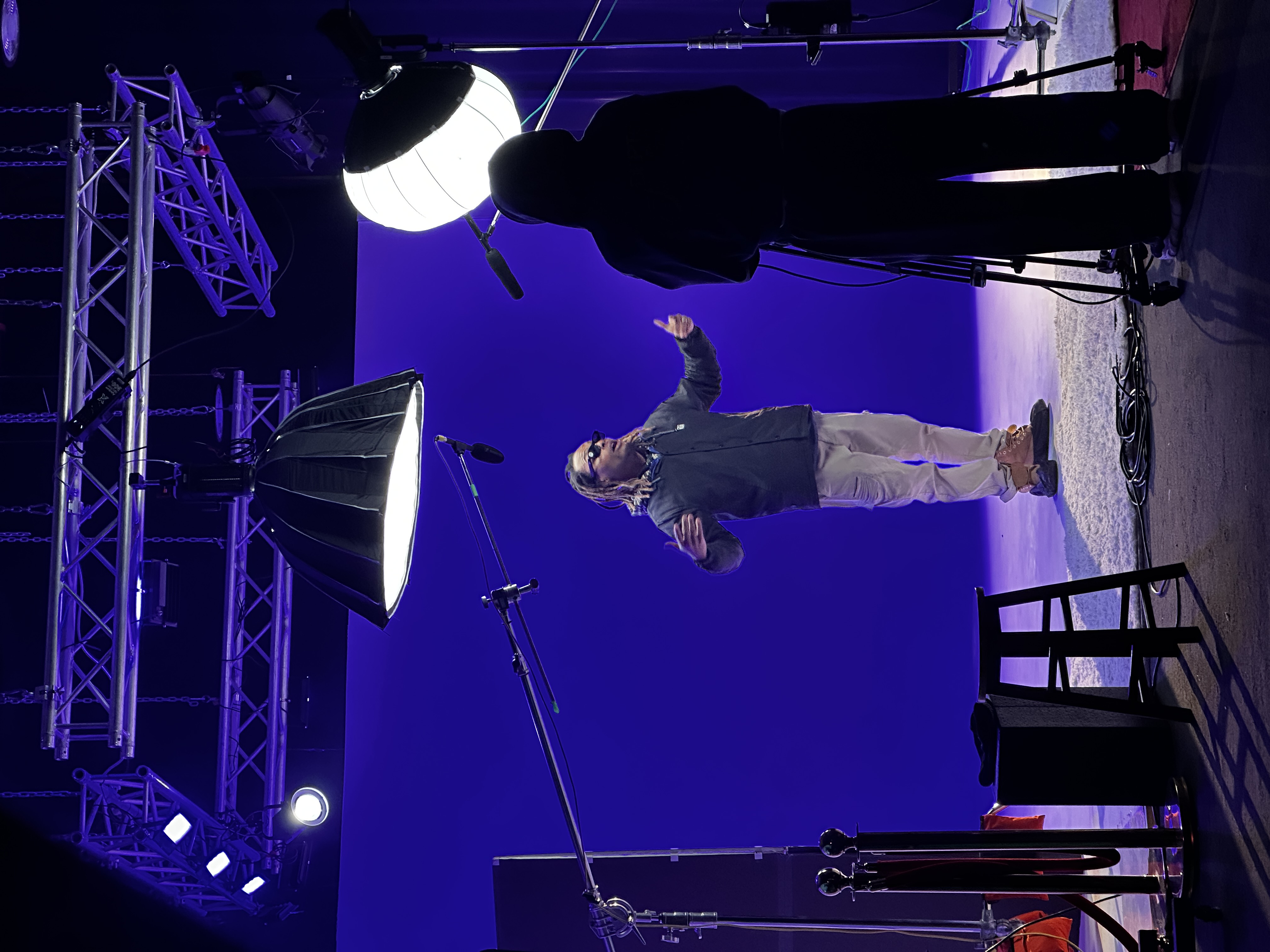 Artist performing on coastal scene with ocean backdrop