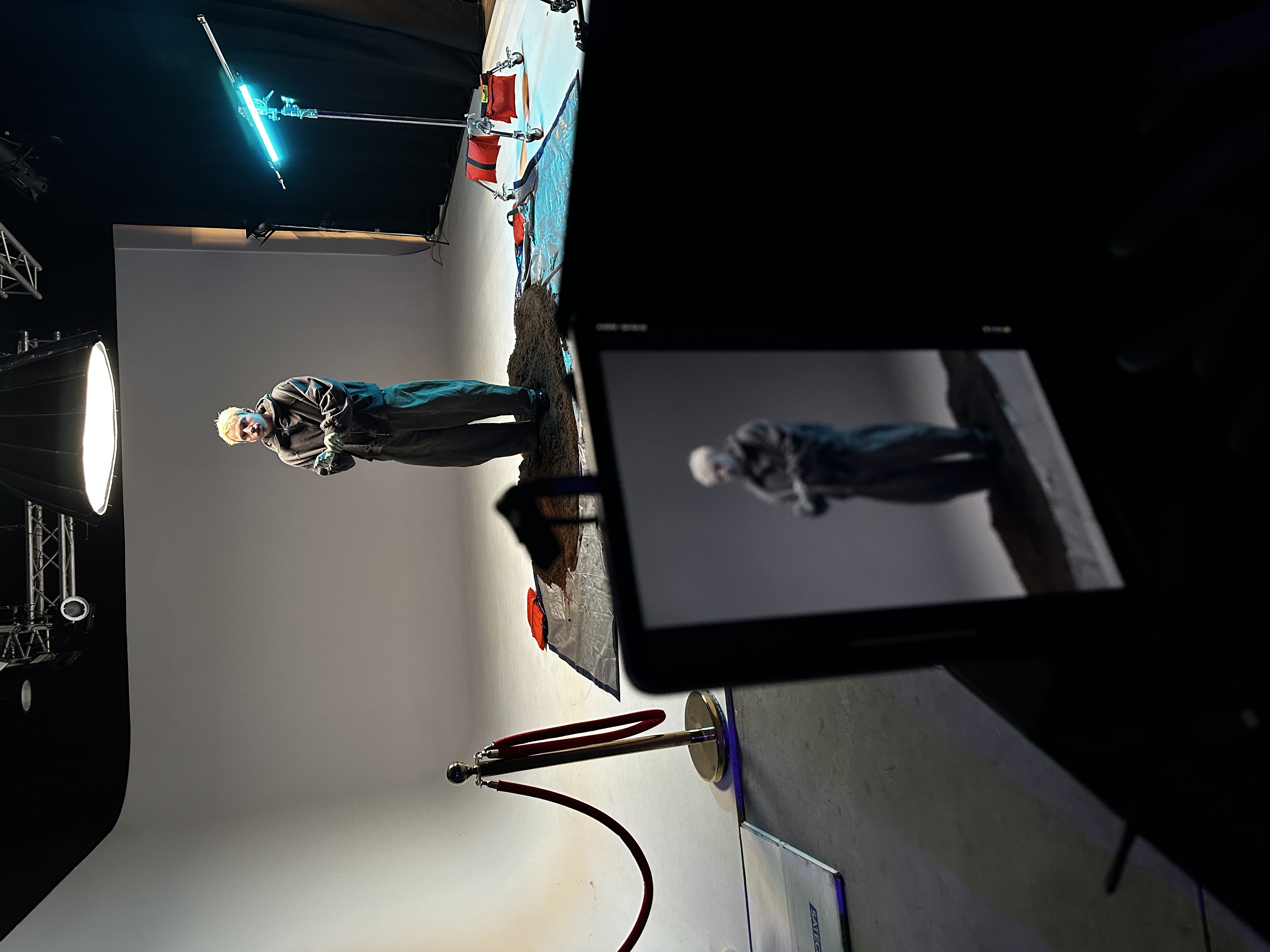 Artist on practical desert set with cyc lighting and monitor playback